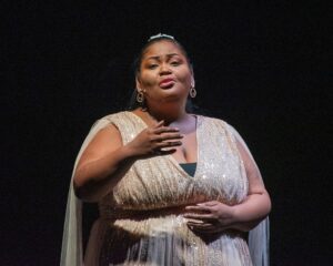 a woman in a dress standing on a stage