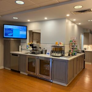 a large kitchen with a tv on the wall
