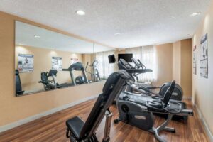 a gym with a mirror and exercise equipment