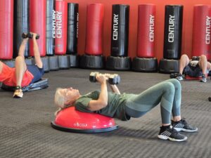 a group of people doing exercises in a gym
