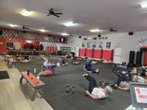 a group of people doing exercises in a gym