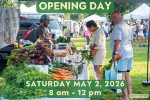 a group of people standing under a tent at a farmer's market