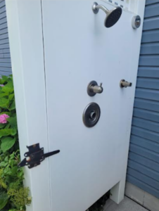 a large white cabinet sitting outside of a building