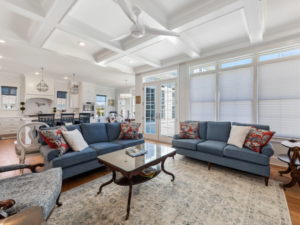 a living room filled with furniture and lots of windows