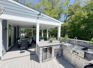 an outdoor kitchen with a grill and sink