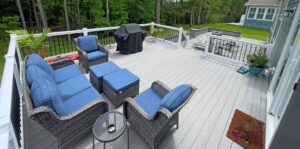 a deck with chairs and a grill on it