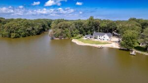 an aerial view of a house on a lake