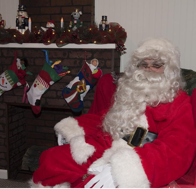 a man dressed as santa claus sitting in a chair