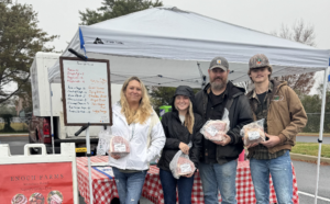 a group of people standing in front of a table