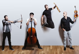 a group of men standing next to each other holding musical instruments