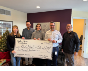 a group of people holding a large check