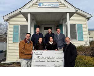 a group of people standing in front of a house