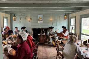 a group of people sitting around a wooden table