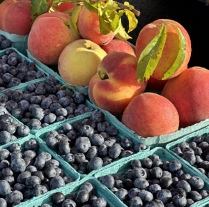 a pile of blueberries and peaches sitting next to each other
