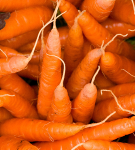 a bunch of carrots are piled up together