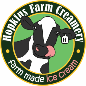 a black and white cow with the words hodkins farm creamery on it