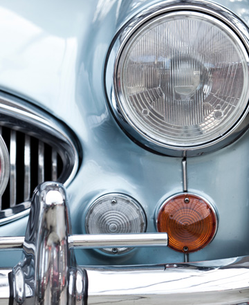 the front end of an old blue car