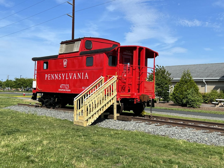 a red train car sitting on the tracks